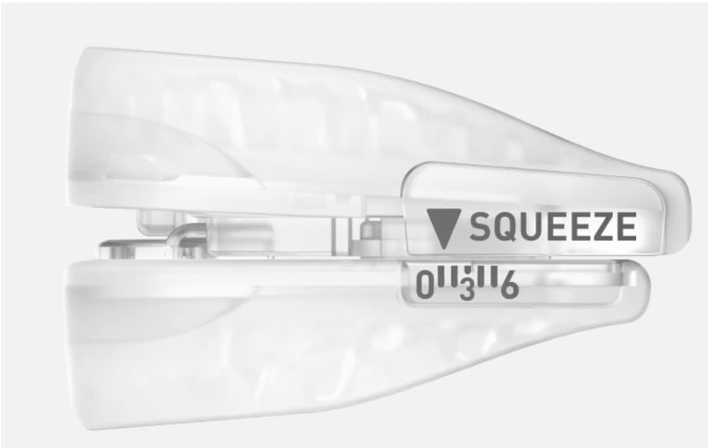 Side view of SnoreRX mouthpiece showing squeeze adjustment and calibration scale